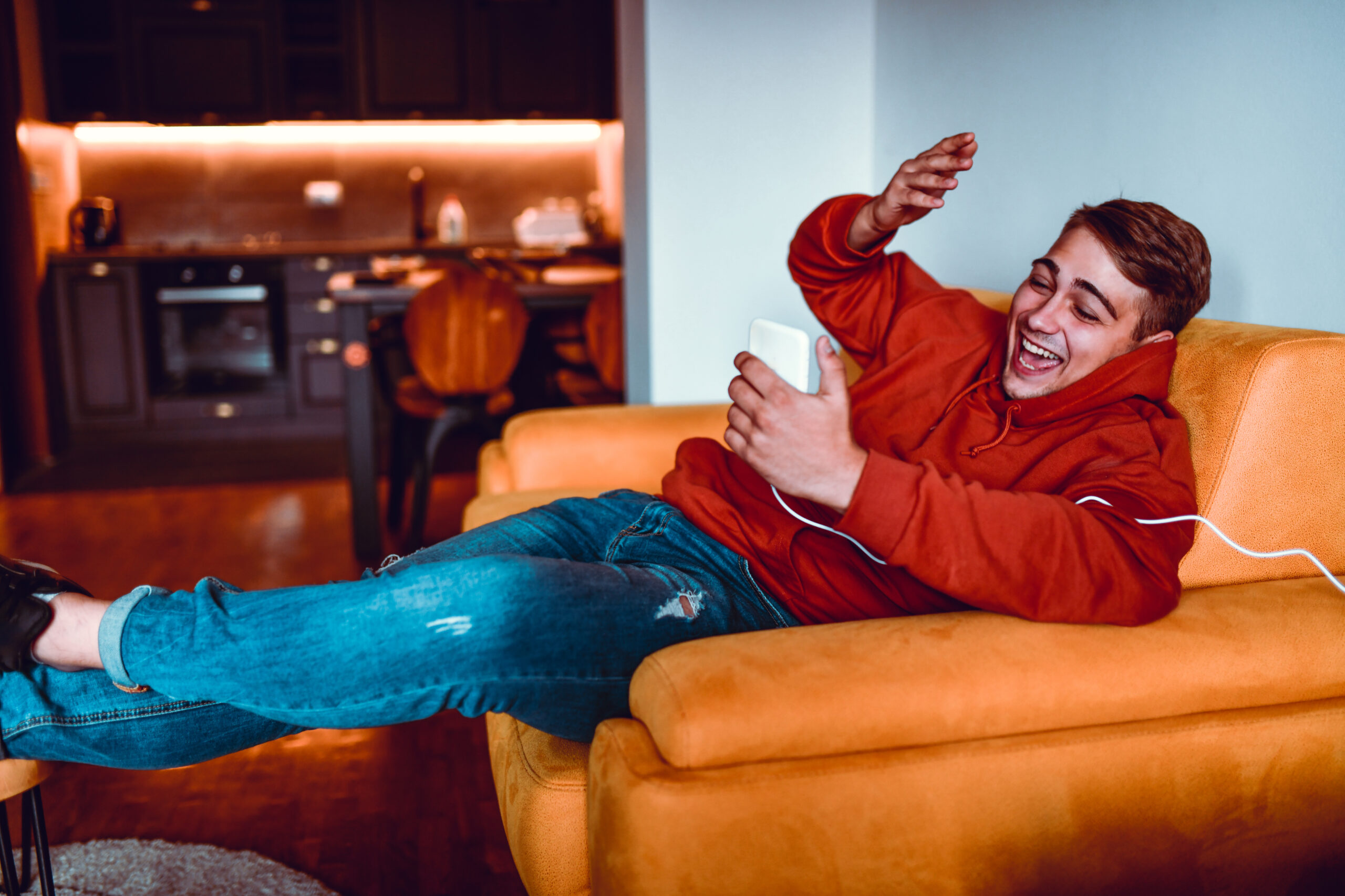 Male Laughing At Funny Pictures On Smartphone